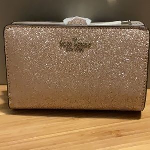 Kate Spade  glitter medium compact bi-fold wallet in Rose Gold